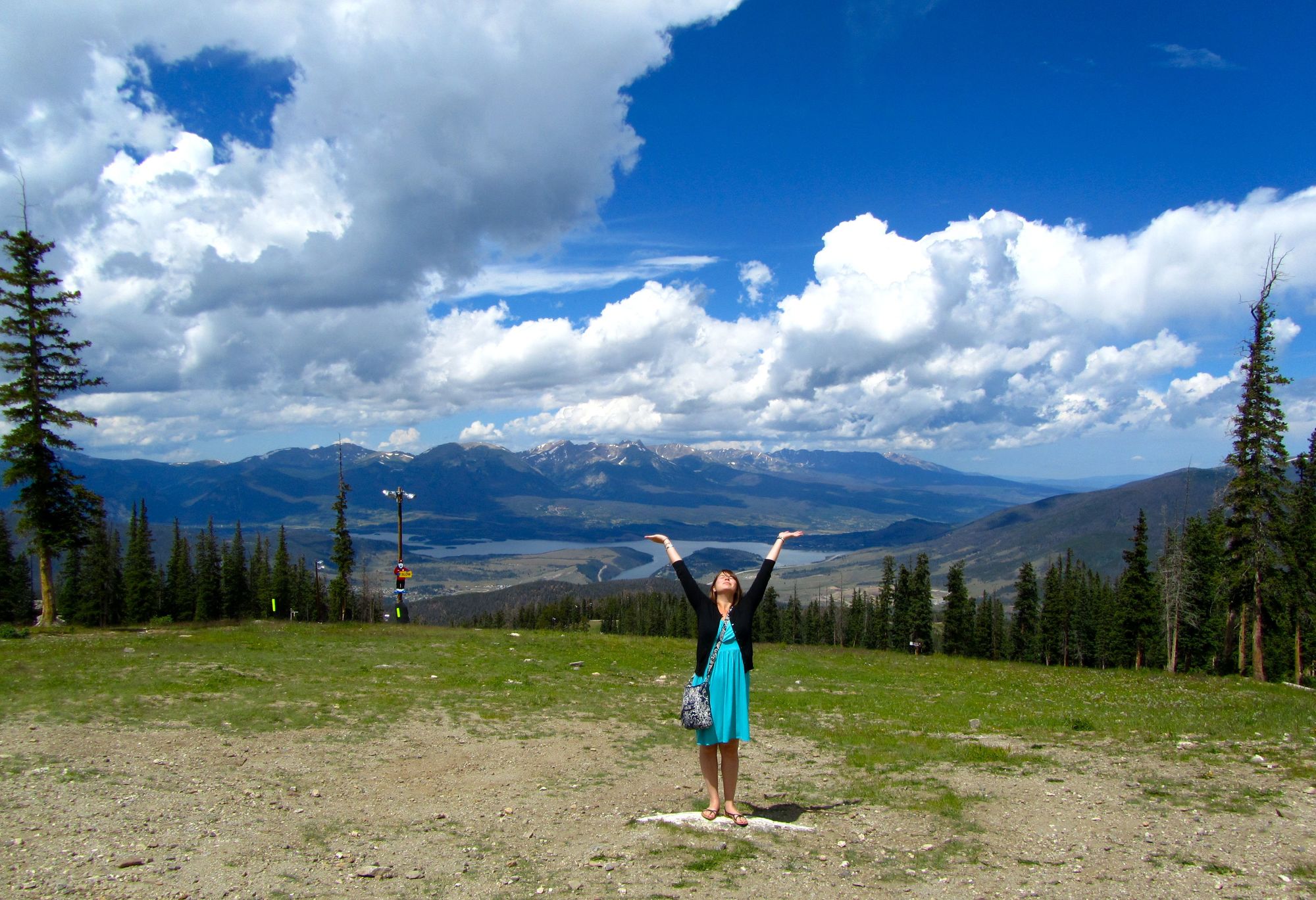 Feature image Girl with arms raised in the Colordao mountains